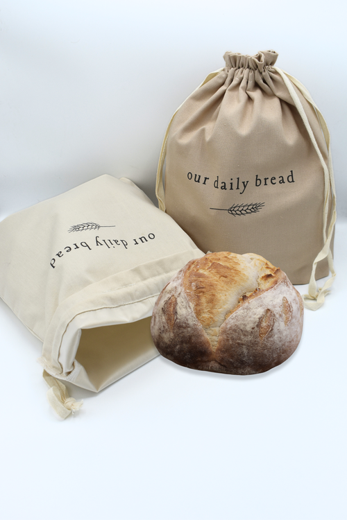 Two linen drawstring bread bags. One beige, one taupe, with washable liner for storing a variety of bread and goods